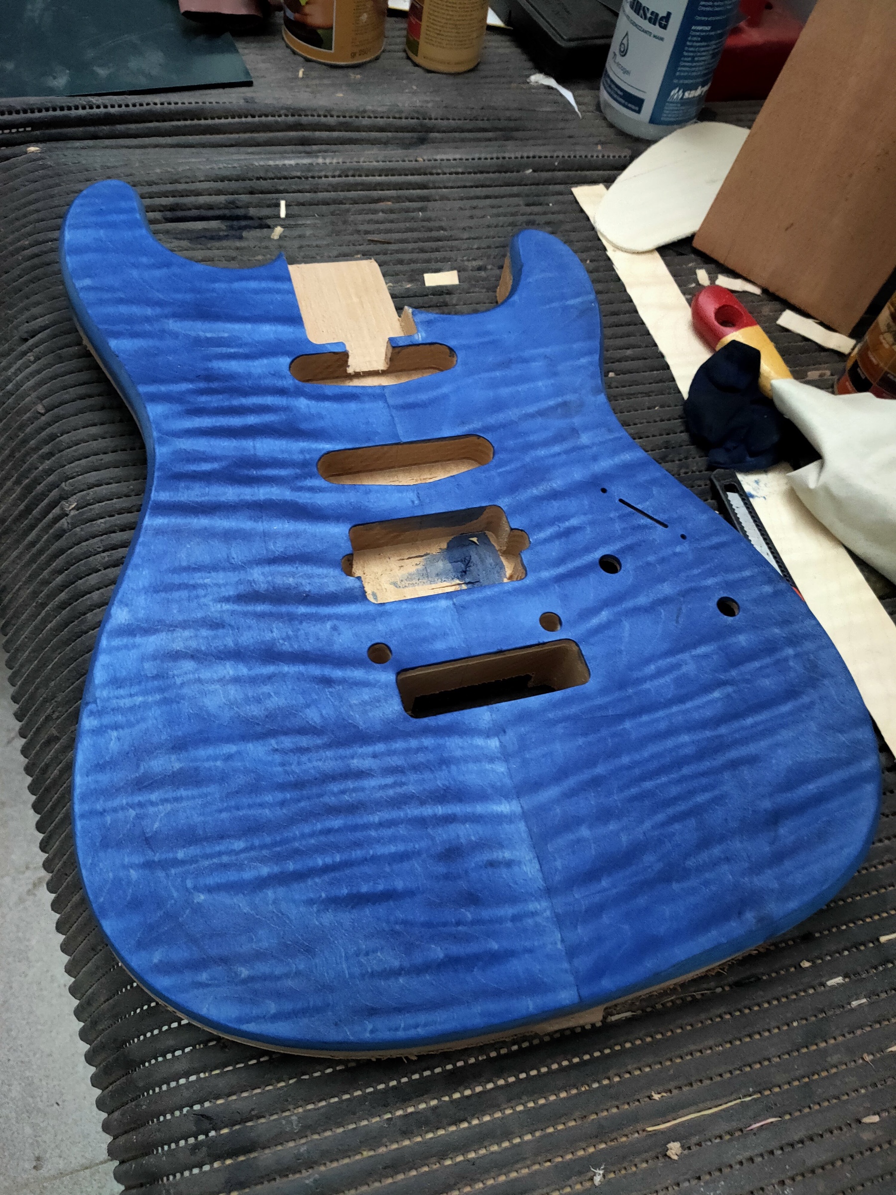 A body with a flamed top stained blue, on the bench grid