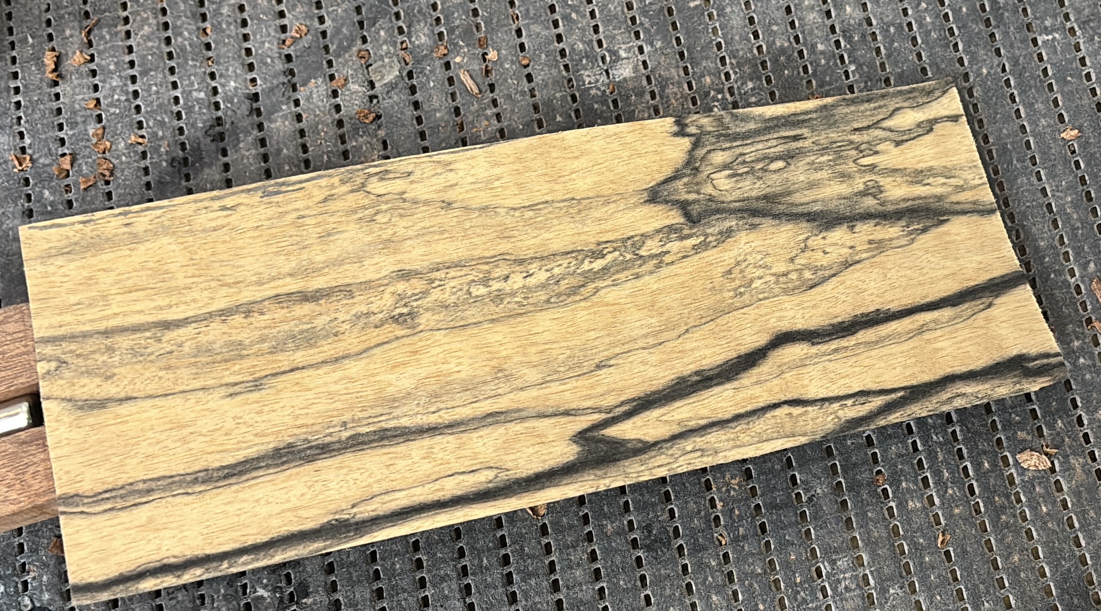 A board of Pale Moon ebony, with its black and cream streaks, on the bench grid