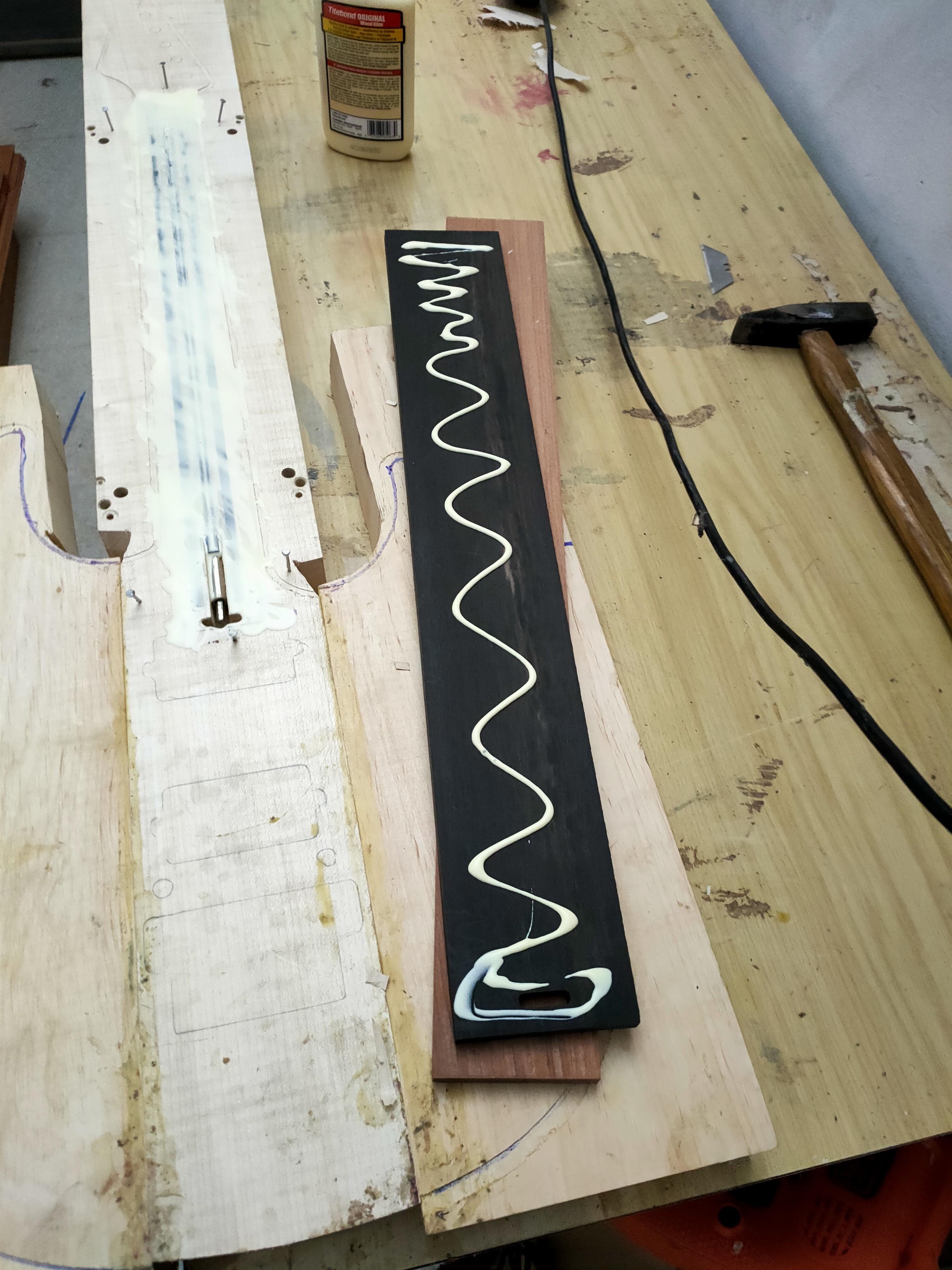 Glue laid down in a serpentine line on an ebony fingerboard