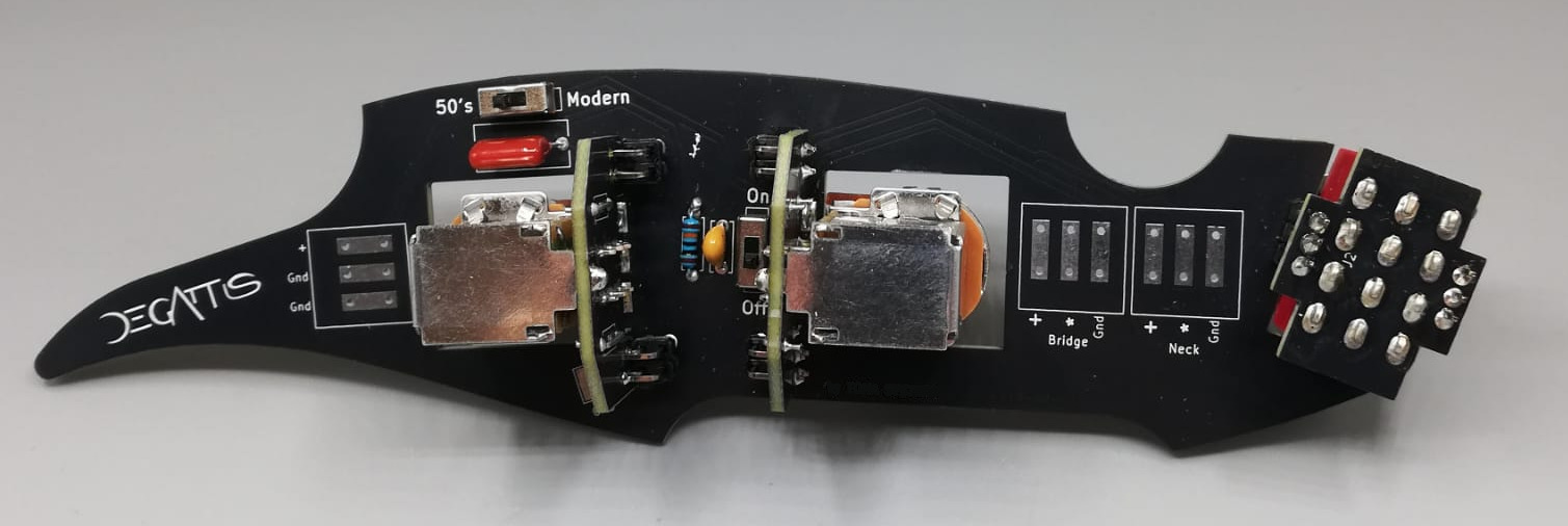 The De Gattis Custom Circuitry board, with the mark engraved on it and the pickup controls